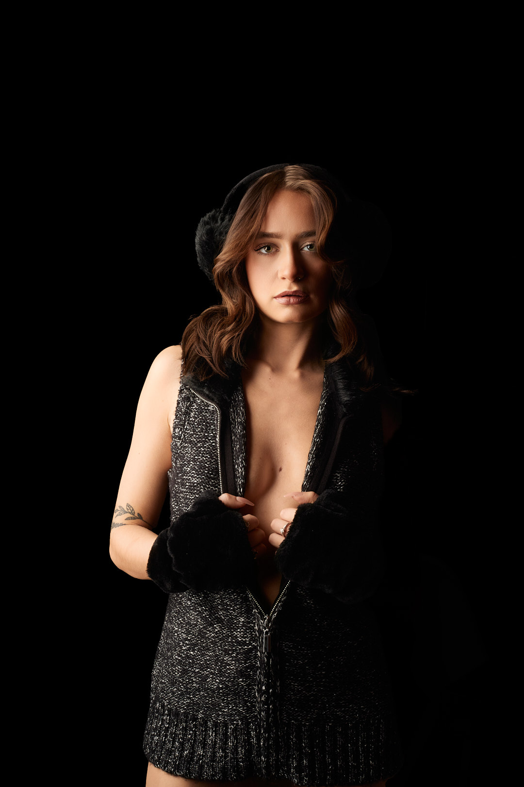 Dark glamour studio fashion portrait woman charcoal boucle zip dress open chest neckline fingerless gloves fluffy headband botanical tattoo nose stud direct gaze one-sided dramatic studio lighting Detroit Metro Michigan