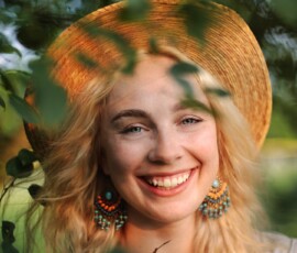 Golden Hour Outdoor Portrait Through Leaves — Rotary Park Livonia Joyful golden hour fashion portrait of woman in straw hat smiling through green leaves at Rotary Park Livonia Michigan