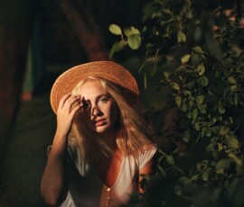 Moody Golden Hour Outdoor Fashion Photography — Rotary Park Livonia Moody golden hour fashion portrait of woman in straw hat and grey dress among foliage with warm light at Rotary Park Livonia Michigan