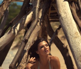 Intimate Beach Fashion Portrait — Hoffmaster State Park Muskegon Intimate fashion portrait of woman in sage green bikini laying in sand inside driftwood structure at Hoffmaster State Park Muskegon Michigan