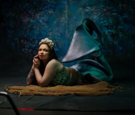 Oakland County Michigan Mermaid Tail Creative Fashion Photography Contemplative mermaid concept fashion portrait of tattooed woman in shell crown and green seashell top with teal mermaid tail Oakland County Michigan