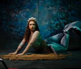 Metro Detroit Creative Mermaid Portrait — Oakland County Michigan Photographer Bold mermaid concept fashion portrait of tattooed woman in shell crown green seashell top teal mermaid tail direct gaze Oakland County Michigan