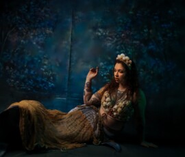 Oakland County Michigan Mermaid Concept Creative Portrait Photography Elegant mermaid concept fashion portrait of tattooed woman in large shell crown and ornate seashell top reclined with teal mermaid tail Oakland County Michigan