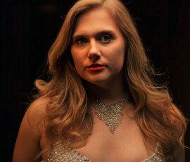 Dramatic Close Up Studio Fashion Portrait — Oakland County Michigan Dramatic close up studio fashion portrait of woman in crystal embellished dress with diamond necklace intense gaze dark background Oakland County Michigan